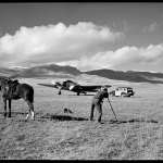 Belden loved to combine images of the new West with the old. Here, he photographs a twin-engine airplane while a pair of dudes look on. Buffalo Bill Center of the West.