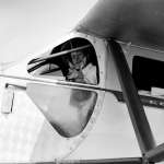 Cody-based pilot Bill Monday with a pronghorn antelope fawn in the cockpit of his single-engine Ryan monoplane. Buffalo Bill Center of the West.