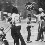 Buhla Teichert helps pedestrians cross the street as Cokeville returns to normal after the bombing. Bill Wilcox photo,  Casper Star-Tribune Collection, Casper College Western History Center.