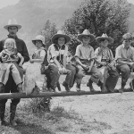 Valley Ranch owner Larry Larom and young dudes, 1930s. The ranch's brand is figured into the front of Larom's boots. Charles Belden photo, American Heritage Center.