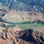 The Dull Knife battlefield from the air. The Cheyenne village of 153 lodges was along the creek in the middle of the photo. Soldiers advanced from the east, at right. Shoshone warriors fired down onto the village from the bluff in the foreground. Cheyenne warriors leapt up from the ravine north of the creek, at center, to stop the cavalry charge. Cheyenne noncombatants escaped up the deep ravine angling from the left toward the upper center. Tom Rea photo.