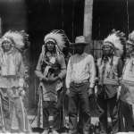 The Farlow family involved itself with Wind River Indians and show business for more than three decades. Shown here, Jule Farlow, center, with, left to right, Arapaho actors Goes-in-Lodge, John Yellow Dress, John Crook and Tom Crispin on the set of "Big Trail," 1930. Lander Pioneer Museum.