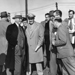 President Harry S. Truman, hands in pockets, at the dedication of Kortes Dam, May 1950. Truman Library.