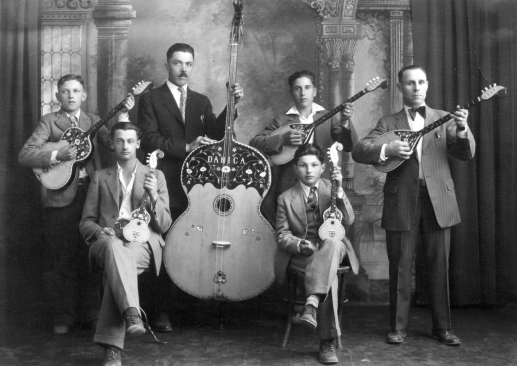 The Gebo Tamburitza Orchestra photographed at the Lindstad Studio, Thermopolis, Wyoming, about 1928. Left to right, Mitch Raicevick, Tom Mesich (Director), Jerry Parezanin, George Vuicich, Mike Maravich, Mike Trbovich. All were Montenegrins. Coal miners of at least 16 different nationalities worked the mines in Gebo and Crosby and lived with their families in those two company towns. American Heritage Center, University of Wyoming.