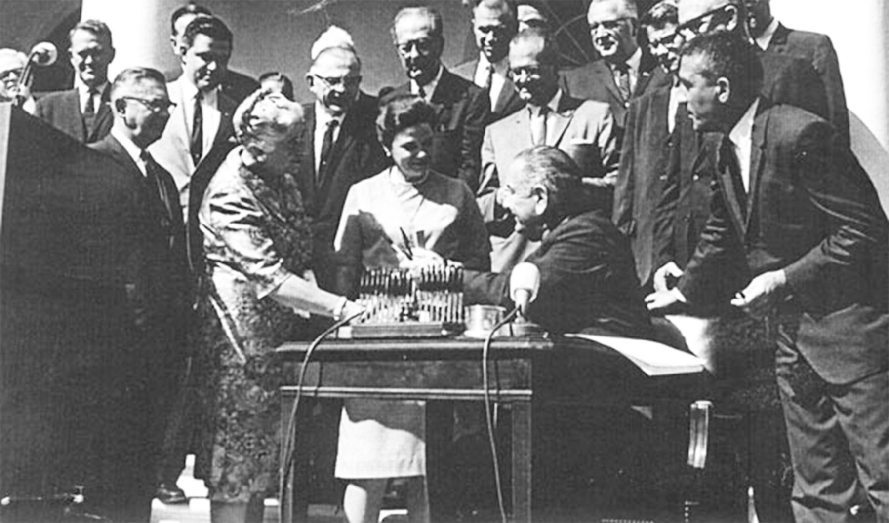 President Lyndon Johnson signs the Wilderness Act, 1964, and hands a pen to Mardy Murie. Conservationist Alice Zahniser stands between Murie and the president; Interior Secretary Stewart Udall at far right. This was a triumph of the Wilderness Society’s long campaign; Howard Zahniser died just two months earlier. The Murie Center.