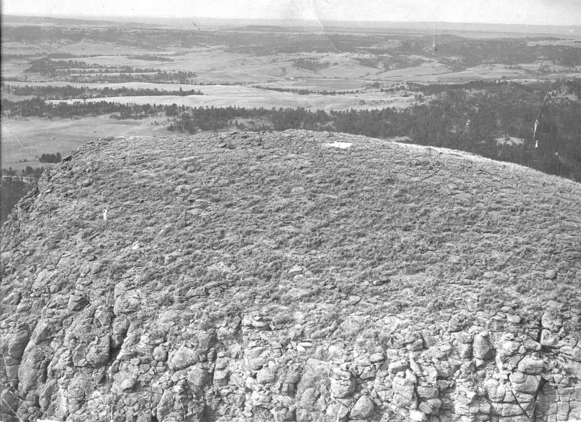 Although Hopkins landed accurately, his rope did not, and he was stranded. This picture shows Hopkins, at left, and his chute on top of the tower. NPS photo.