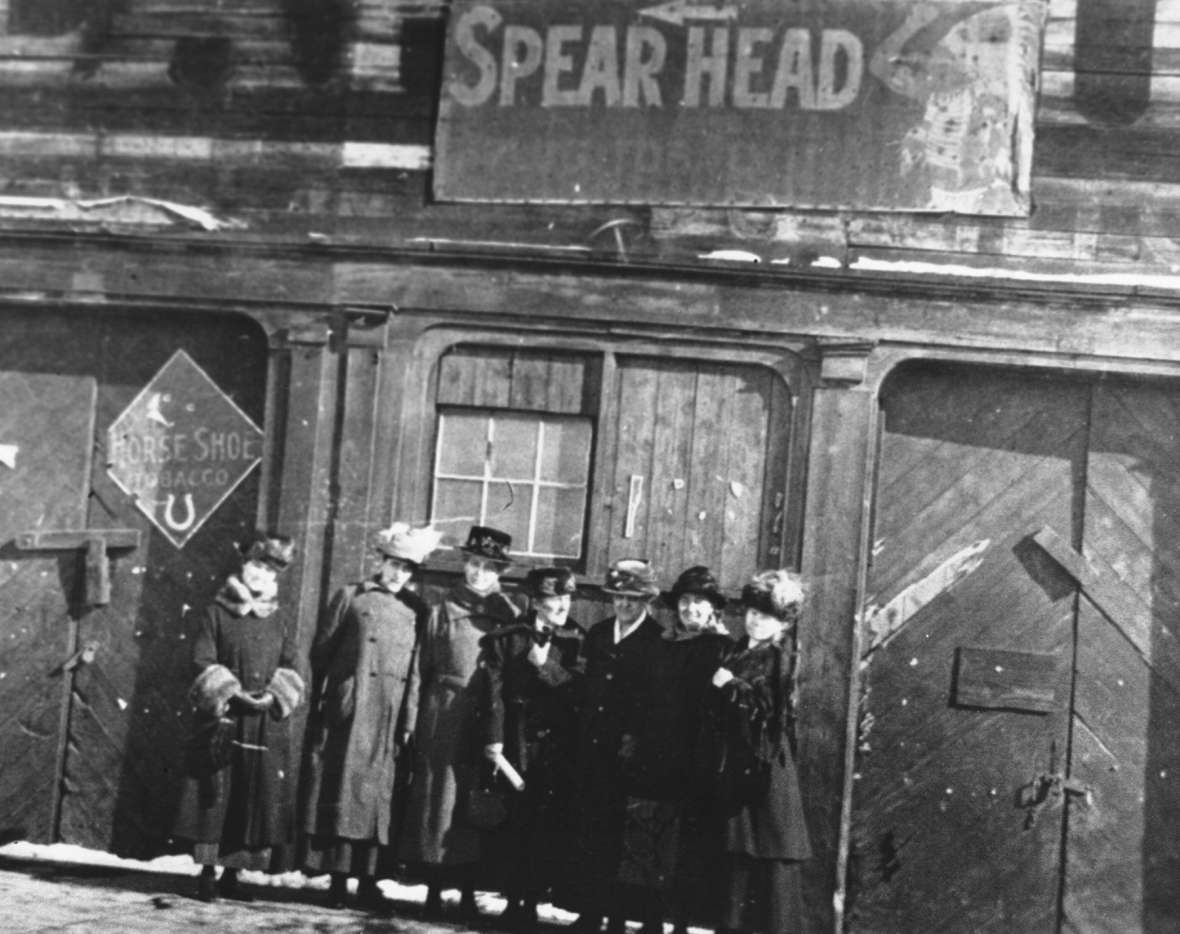 In 1919, when nationally prominent suffragist Carrie Chapman Catt, third from right, was in Wyoming to lobby for ratification of the 19th Amendment and found a chapter of the new League of Women Voters, local professor and suffragist Grace Raymond Hebard, center, and women in Catt’s party visited the site of the first courtroom where women served on a jury—once the Trabing Brothers store, by then the disused Variety Theater. American Heritage Center