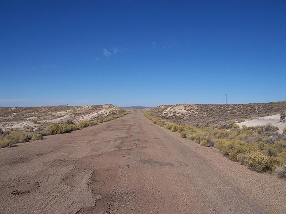 road through open plains without trees