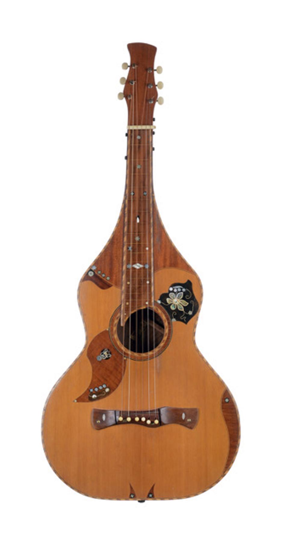 Chris Knutsen hollow-neck acoustic steel guitar, 1920s. From shops in Washington state, Knutsen patented and produced a variety of steel, harp and regular guitars beginning in the 1890s. Connecting with Hawaiian musicians at fairs and expositions, he produced ideal instruments for the time that are still played and copied today. Courtesy of Gregg Miner.