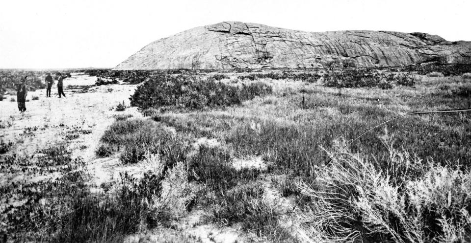 Independence Rock from the southwest, 1870. William Henry Jackson photo. The sandy swale in the trail in the foreground is now crossed by a low footbridge on the path from the highway rest area to the rock.