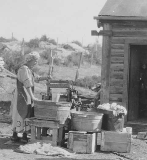 Ethel on laundry day, 1917, at the family’s new gasoline-powered Maytag washing machine. Love family photo.