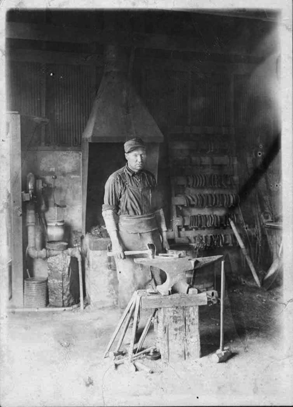 John Bastalich, who worked for the Union Pacific Coal Company for many years, in the blacksmith shop in Reliance, 1913. Sweetwater County Historical Museum photo.