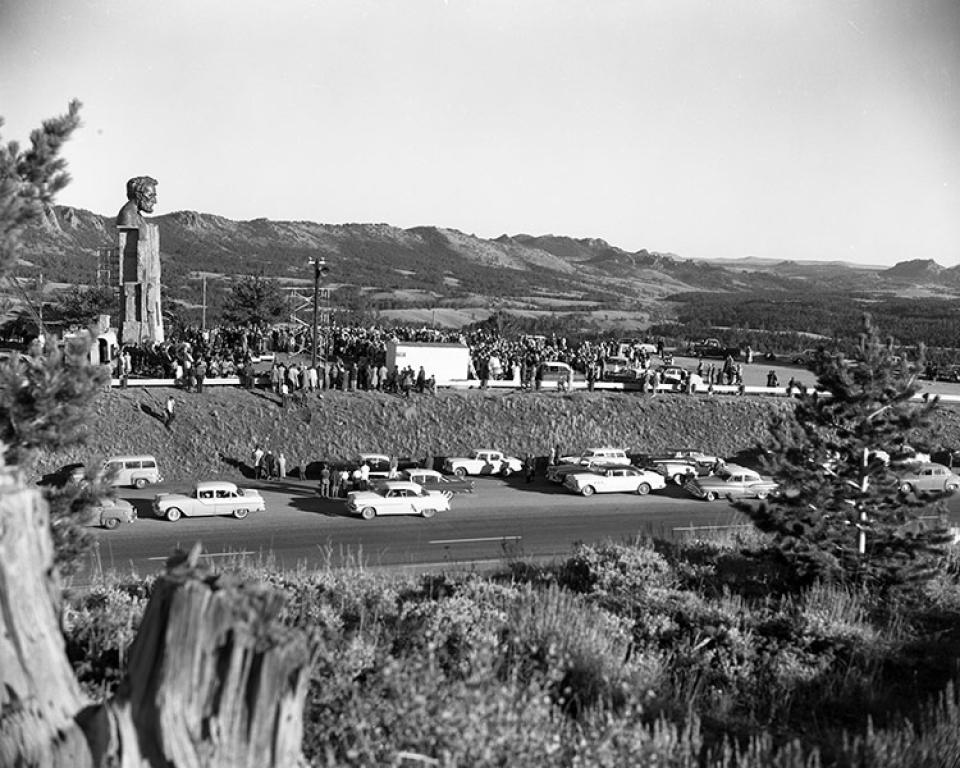 Dedication of Russin's Abraham Lincoln Memorial, 1959, at the highest point on the transcontinental Lincoln Highway, 8,835 feet above sea level. The spot was on what's now the service road between exits 323 and 329 of Interstate 80. After I-80 opened in 1969, the bust and its based were moved about a mile to the present location near exit 323 at a slightly lower elevation, 8,640 feet. UW photo service.