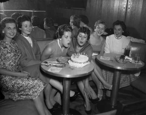 Pat Sloan of Louisville, Ky., center left,  and Ann Dempsey of Seattle, center right, celebrate their birthdays in June 1958 with other trainee friends at the Wigwam Lounge in the Plains Hotel, Cheyenne, a favorite trainee meeting place at the time. Wyoming State Archives.