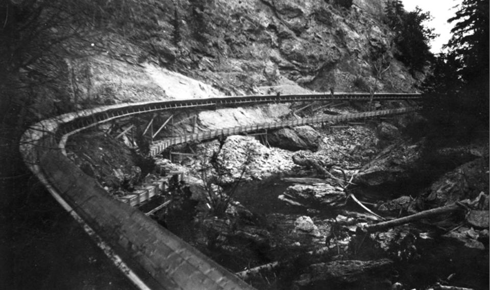 The completed tie flume transported about 300,000 ties per season to the Wind River. Extra water ran in the smaller aqueduct below the main flume. Wyoming State Archives.