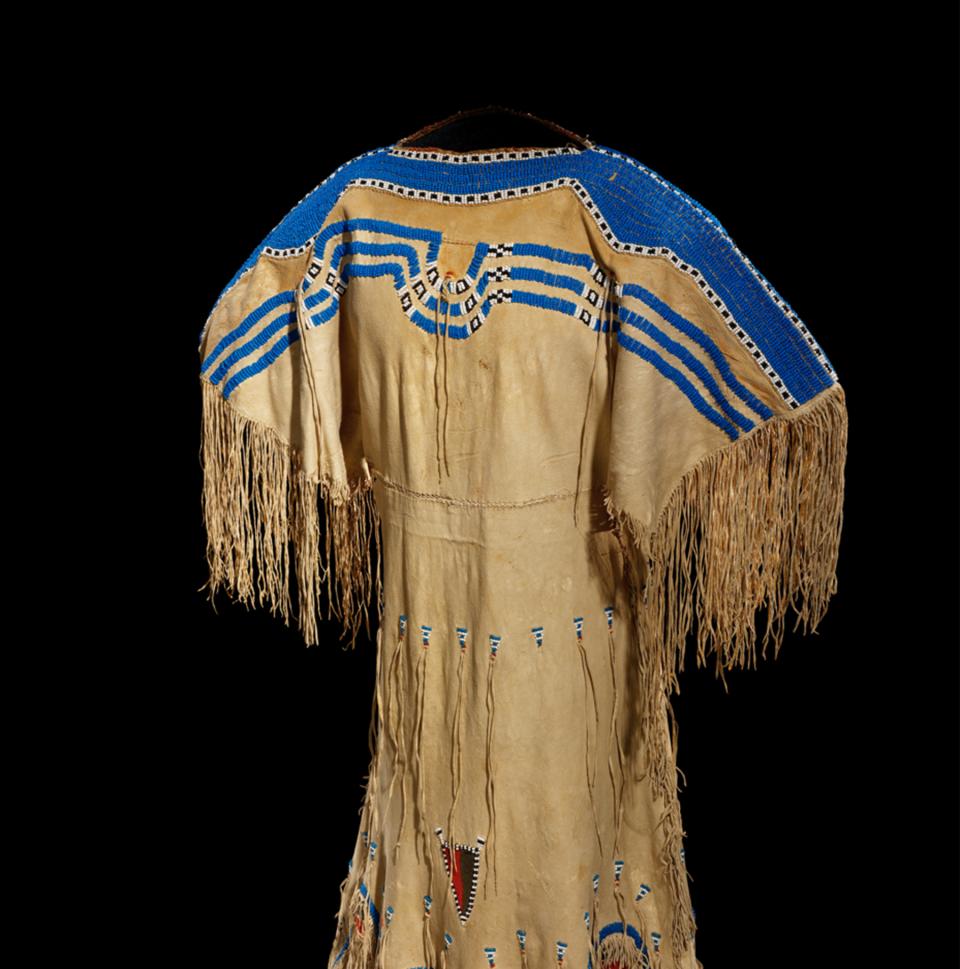 Pikuni Blackfeet (Piegan) woman’s dress ca. 1855-60, made of deer hide with small and large glass beads, wool cloth and sinew.  NMAI, Smithsonian Institution, catalog number 10/8454.