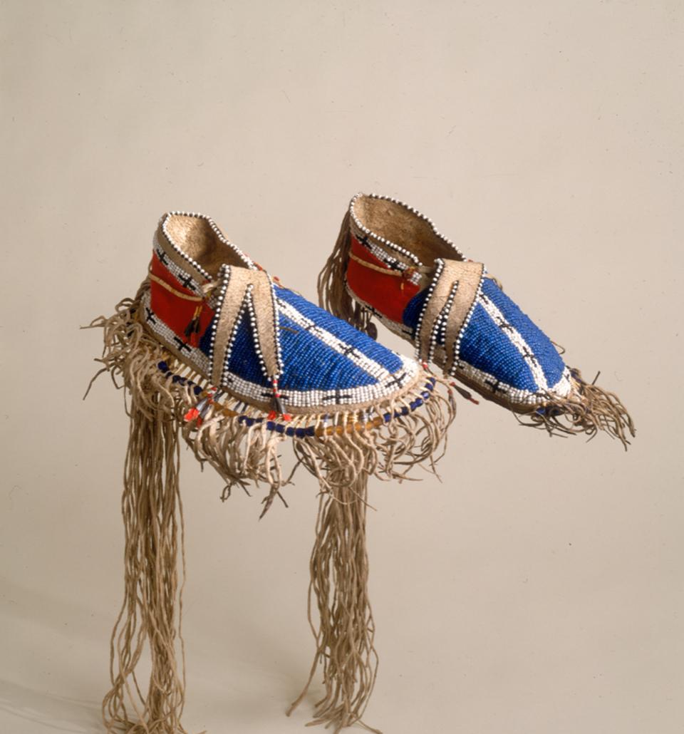 Exceptional Northern Plains moccasins made with hide, glass pony and smaller beads, wool cloth, metal cones and porcupine quills, about 1855-1860.  Such refined footwear would have been worn by Lakota dignitaries visiting Fort Laramie and the region. NMAI, Smithsonian Institution, catalog number 8/8057. 