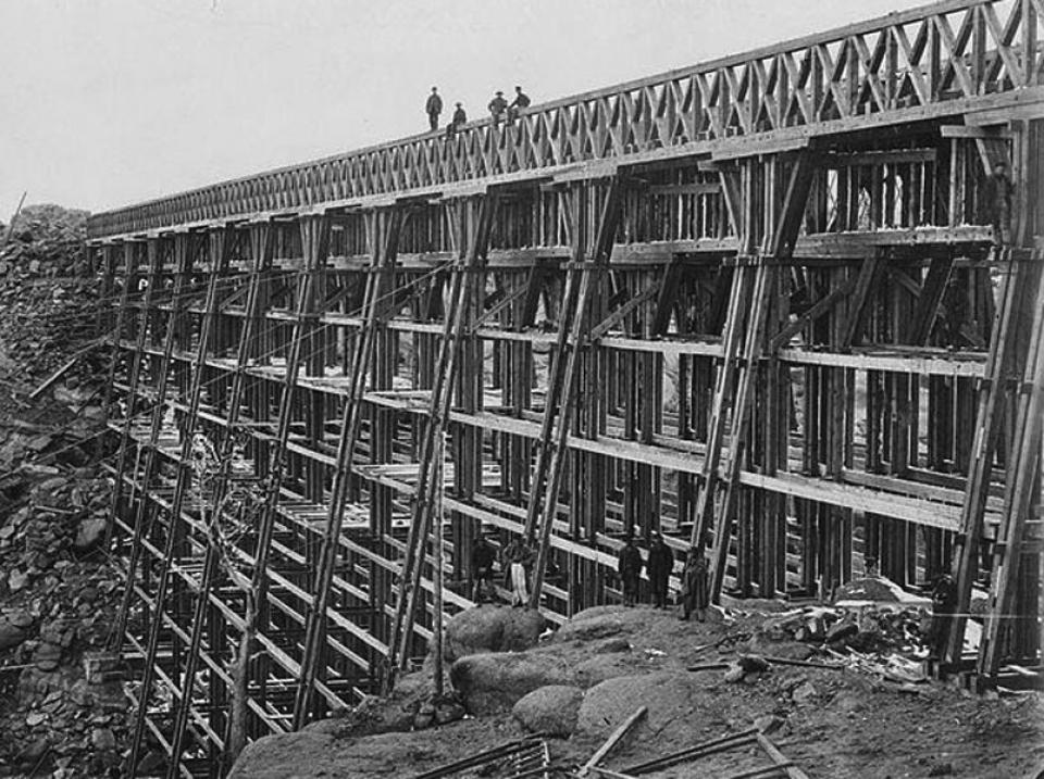 The Dale Creek trestle, 125 feet high and 1,400 feet long, brought the UP line down into Laramie after it came over the summit from Cheyenne. A.J. Russell, 1869. Wikipedia.