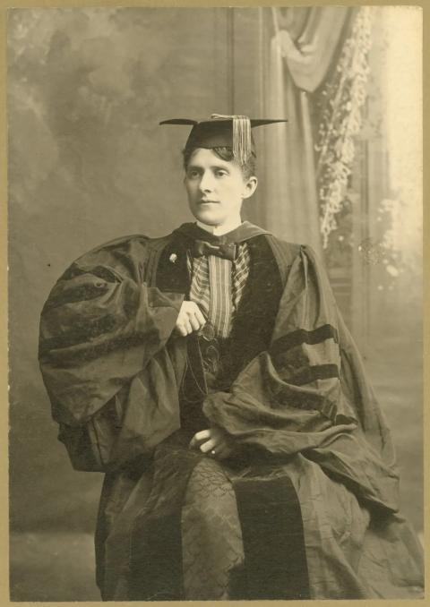 Studio portrait of woman wearing cap and gown