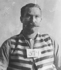 Bub Meeks, shown below in an Idaho State Penitentiary photo, was sentenced in 1896 to 35 years there. His sentence was later reduced; he would have been eligible for parole in 1904. But on Christmas Eve 1901 he cut a horse out of a wagon harness and escaped, was quickly caught, escaped again 20 months later and was shot in the leg. His leg was amputated. A few days later he attempted suicide by jumping off a cell house wall.  Idaho State Archives. 